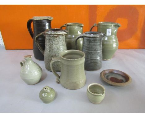 Probably Leach of St Ives - A collection of mainly celadon glazed studio pottery comprising five jugs, a tankard, a cruet set