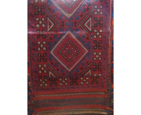 An Eastern wool runner principally in a red and blue colourway with multi-medallion centre within running borders, 245 cm x 6