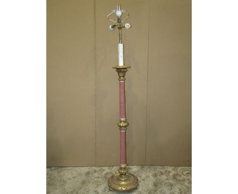 Gilt wood standard lamp with foliate detail, the stem partially upholstered and raised on a disc shaped platform base with tu