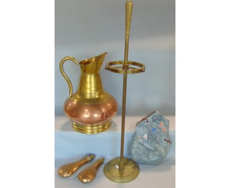 A large copper and brass ewer with loop handle, cylindrical stick stand, two powder flasks and a slate with a painted galleon