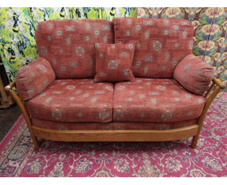 Ercol 'Renaissance' light elm three piece lounge suite, comprising two seat sofa and two armchairs with bent spindle back fra