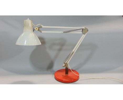 A vintage anglepoise lamp with circular weighted base in red, the remainder in white 