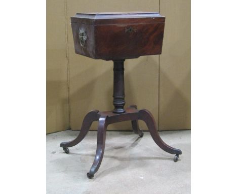 A Regency mahogany sarcophagus shaped teapoy with inlaid banded detail, the hinged lid enclosing a partially fitted interior 