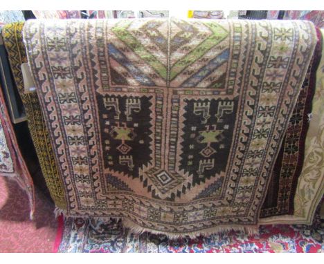 A coarse wool rug in the Persian style, the central medallion upon a chocolate coloured ground depicting figures and animals 