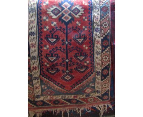 Persian wool runner the central red ground field with repeating geometric detail within alternating white and blue ground bor