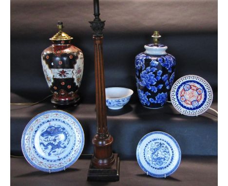 A carved, turned and fluted lamp standard with ionic capital, together with two Chinese ceramic ovi-form vases, adapted as ta