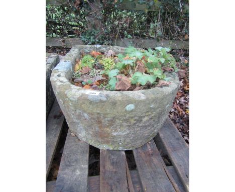 A weathered natural stone trough of rectangular form with single D end, 80 cm long x 53 cm wide x 26 cm in height (planted) 