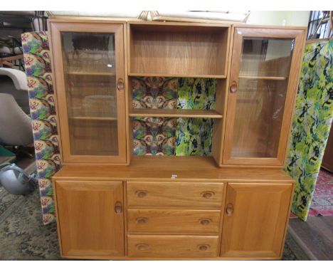 Ercol light elm sideboard, the raised back with two glazed door shelving compartments, framing a further shelving recess, ove