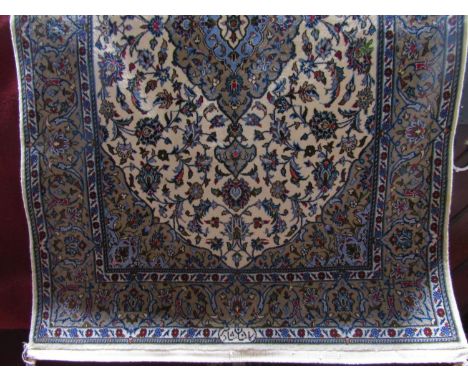 A Persian style wool carpet, the cream ground bearing a central medallion with floral detail within further alternating runni