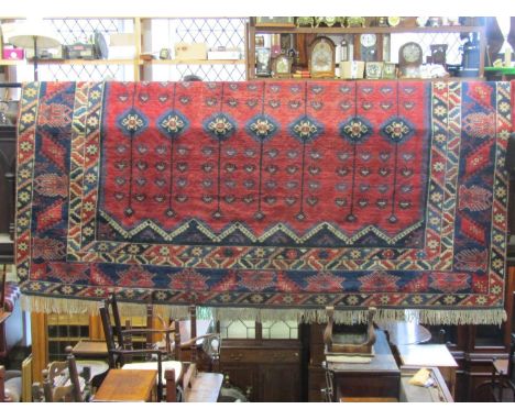 A large good quality Turkish Dosemealti carpet, principally in a blue and red colourway with repeating design throughout, 4 m