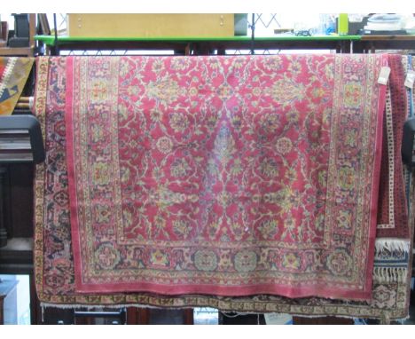 Belgian carpet in the Persian style with red ground, repeating floral detail and within running borders, 270 x 220 cm approx 