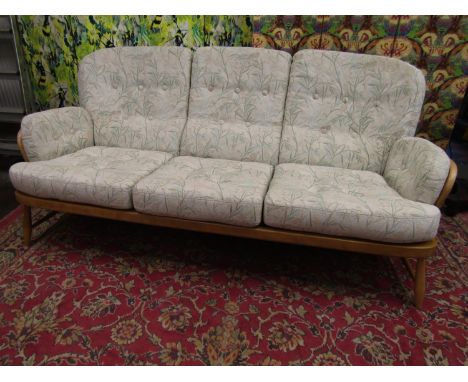 Ercol light elm Jubilee three piece lounge suite with spindle back, three seater sofa and two lounge chairs, the sofa 190cm l