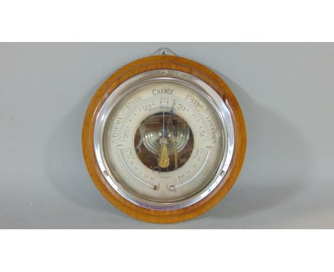 White Thomson &amp; Co of Glasgow chrome bulkhead wall clock, the silvered dial with barometer and thermometer upon an oak pl