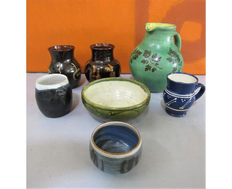 A mixed collection of studio pottery comprising a blue glazed jug, possibly by Michael Casson, a further bowl by Victor Hugo,