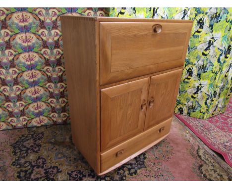 Ercol light elm bureau, the fall front enclosing a part fitted interior over two cupboard drawers and a single drawer, 110cm 