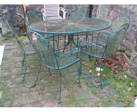 A green painted light steel seven piece garden suite with lattice, simple scroll and foliate detail, comprising oval table an