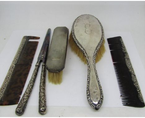 A mixed collection of silver to include a cigarette box with engine turned detail, a silver backed brush with two combs, a si