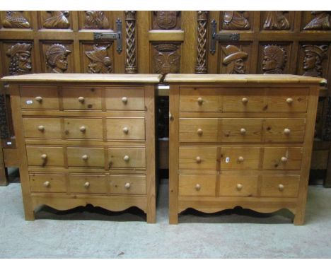 A pair of small stripped pine four drawer bedroom chests disguised as twelve short with turned button handles and shaped apro