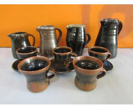 Collection of probably Leach pottery St Ives table wares all in brown glaze comprising four jugs, five tea cups and three sau