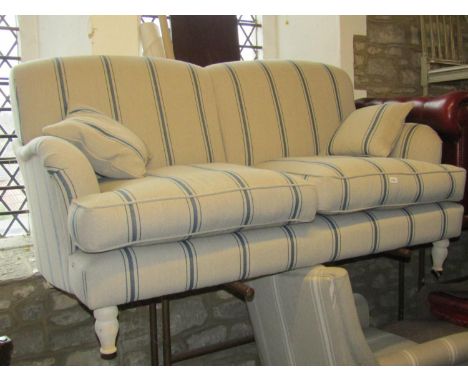 A contemporary two seat sofa with striped detail raised on turned supports, 170 cm wide approx 