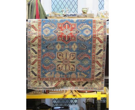 A Turkey wool carpet with mid blue field, three medallion with geometric decoration within alternating running borders, 250 x