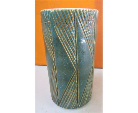 Interesting Poole Pottery cylinder vase with green over glaze and incised geometric decoration, 23cm high