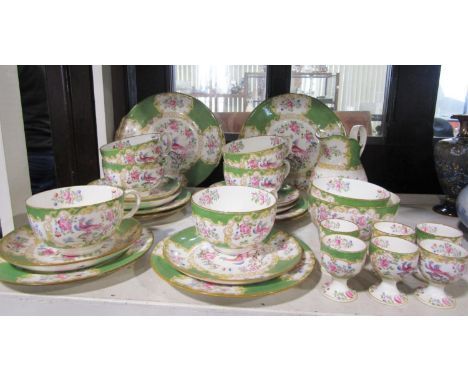 A collection of Mintons breakfast wares with chinoiserie style bird decoration comprising a pair of serving plates, milk jug,