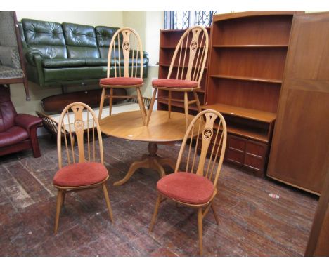 Ercol light elm extending kitchen table, upon a turned baluster column and four splayed legs, together with a set of four Win