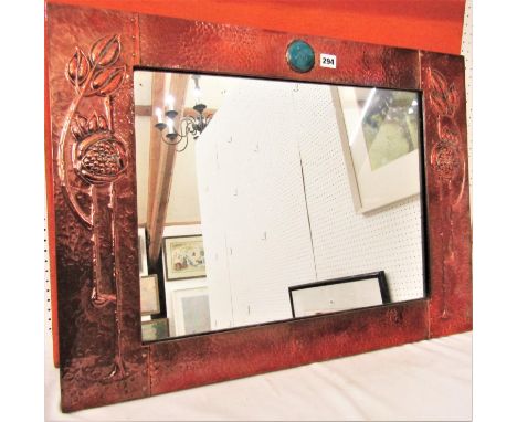 In the manner of Archibald Knox for Liberty - Planished copper rectangular wall mirror, centrally fitted with a Ruskin turquo