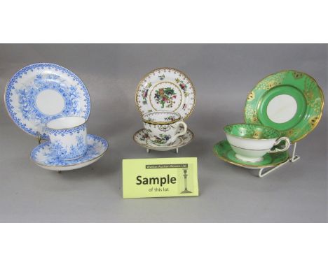 A collection of Minton tea wares with green and gilt border decoration comprising cake plate, milk jug, slop bowl, three cups