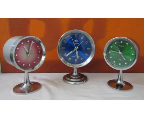 Matched pair of Rhythmn alarm clocks on chrome tulip bases together with a similar Frontier clock (3) 