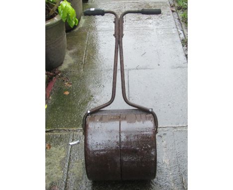 A small vintage cast iron garden roller 