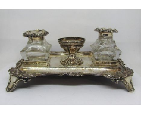 A Victorian silver stand dish of rectangular form, with raised and shaped C scroll and floral borders, set with two square cu