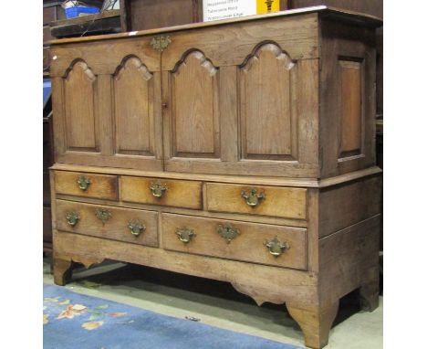 A Georgian oak two sectional mule chest later converted to a side cupboard, enclosed by fielded arched panelled doors over an