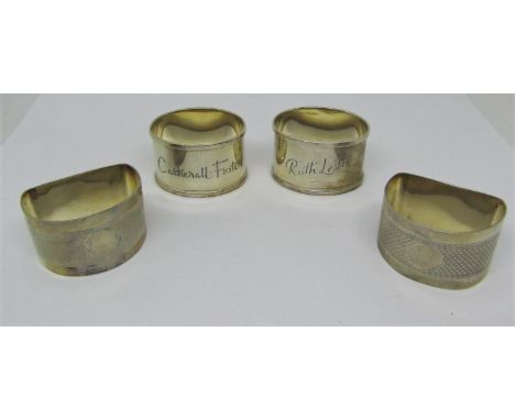 Four silver napkin rings, with engraved or engine turned detail, 3oz approx, together with a cased set of six silver handled 