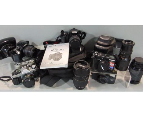 A collection of photographic equipment including a Pentax SLR digital camera, K100d, with Tamron additional lens and with ins