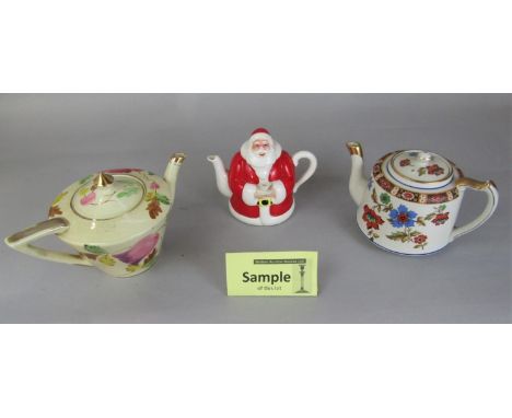 A collection of novelty teapots including art deco style examples, Wade example from the Feline Collection, and a Carlton war