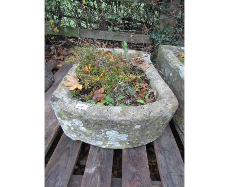 A weathered natural stone trough of rectangular form with single rounded end, 72 cm long x 46 cm wide x 22 cm height (planted