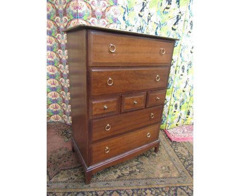 Stag Minstrel Tallboy, fitted with an arrangement of seven drawers upon bracket feet, 113cm high x 82cm wide 