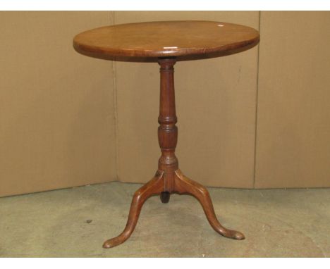 A Georgian mahogany snap top table, the circular one piece top, raised on a vase shaped pillar and tripod, 60cm diameter 