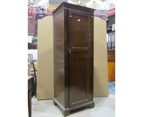 An Edwardian sentry box hall robe enclosed by a full length twin panelled door raised on bracket supports, 66 cm wide x 56 cm