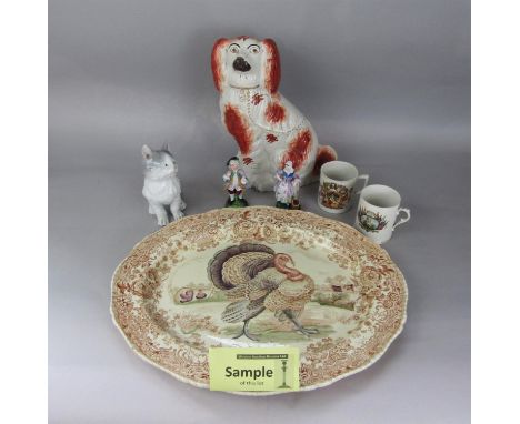 A 19th century Staffordshire spaniel, a Poole Pottery white glazed model of a cat, a continental model of a long furred grey 