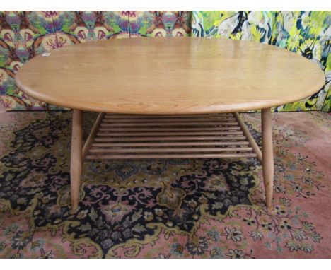 Ercol light elm circular coffee table with spindled under-tier, 44cm high x 100cm long 