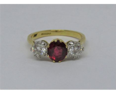 18ct three stone ruby and diamond ring, diamonds 0.30cts each approx, size N/O, 4.2g 