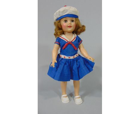 A 1950's Shirley Temple doll in sailor dress with closing eyes, height 36cm, together with 3 small bisque head dolls, 2 with 