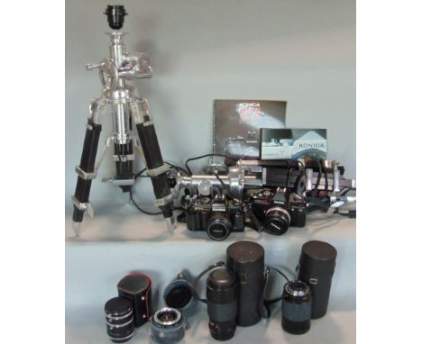 A Konika Autoreflex TC camera, another - FT-1 model together with lenses manuals, etc, together with two telescopic tripod st