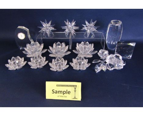 A collection of Swarovski crystal and similar items including a paperweight by Daniel Swarovski, a set of three candleholders