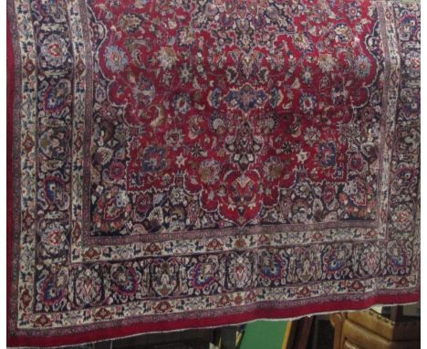 A large Mashan full pile carpet, with various typical scrolled foliate Islamic decoration upon red and blue ground, 400 x 300