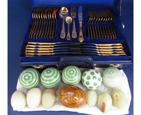 A Solingen West German canteen containing a quantity of flatware with gilt effect handles, in blue carrying case, together wi