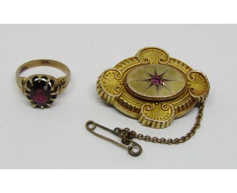 9ct claw set garnet ring, size N and an antique 15ct brooch set with a pink ruby, 13.7g total (2) 